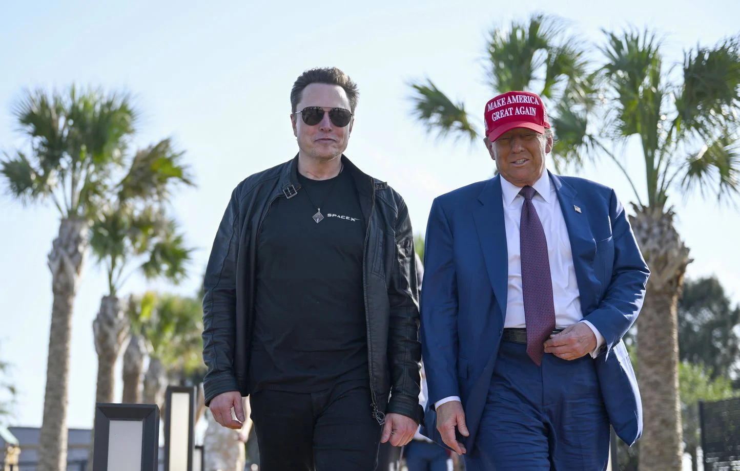donald trump walks with elon musk